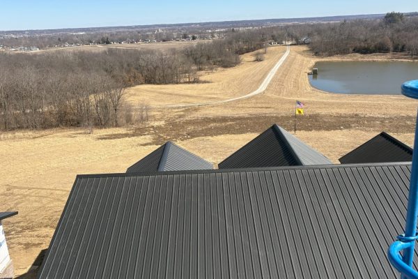 Standing seam metal roof system on a new building with raised interlocking seams and concealed fasteners for durability, longevity, and weather-resistant performance.