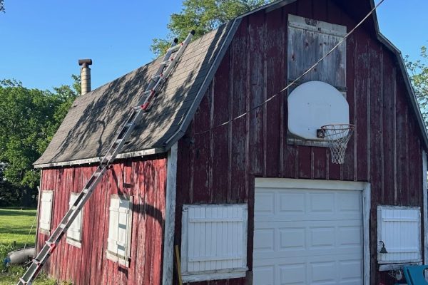Barn with a gambrel-style roof featuring dual slopes that maximize interior loft or storage space and provide a classic rustic appearance.