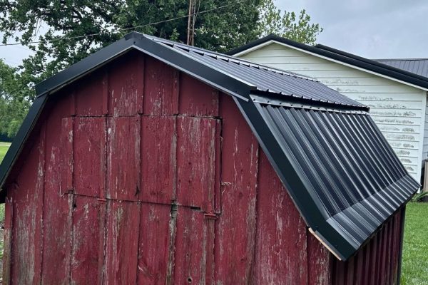 Barn with a gambrel-style roof featuring dual slopes that maximize interior loft or storage space and provide a classic rustic appearance.