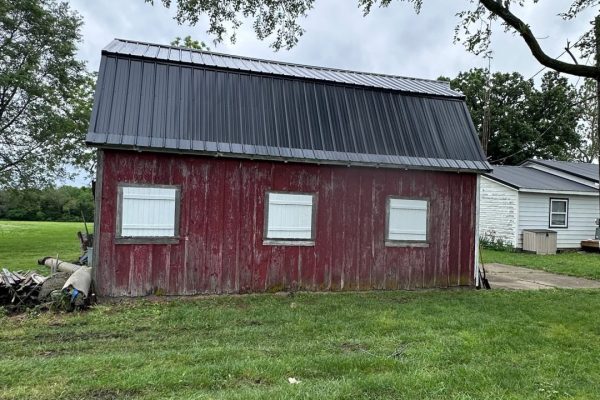 Barn with a gambrel-style roof featuring dual slopes that maximize interior loft or storage space and provide a classic rustic appearance.