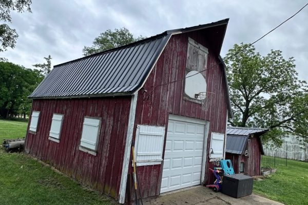 Barn with a gambrel-style roof featuring dual slopes that maximize interior loft or storage space and provide a classic rustic appearance.