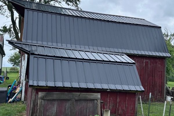 Barn with a gambrel-style roof featuring dual slopes that maximize interior loft or storage space and provide a classic rustic appearance.