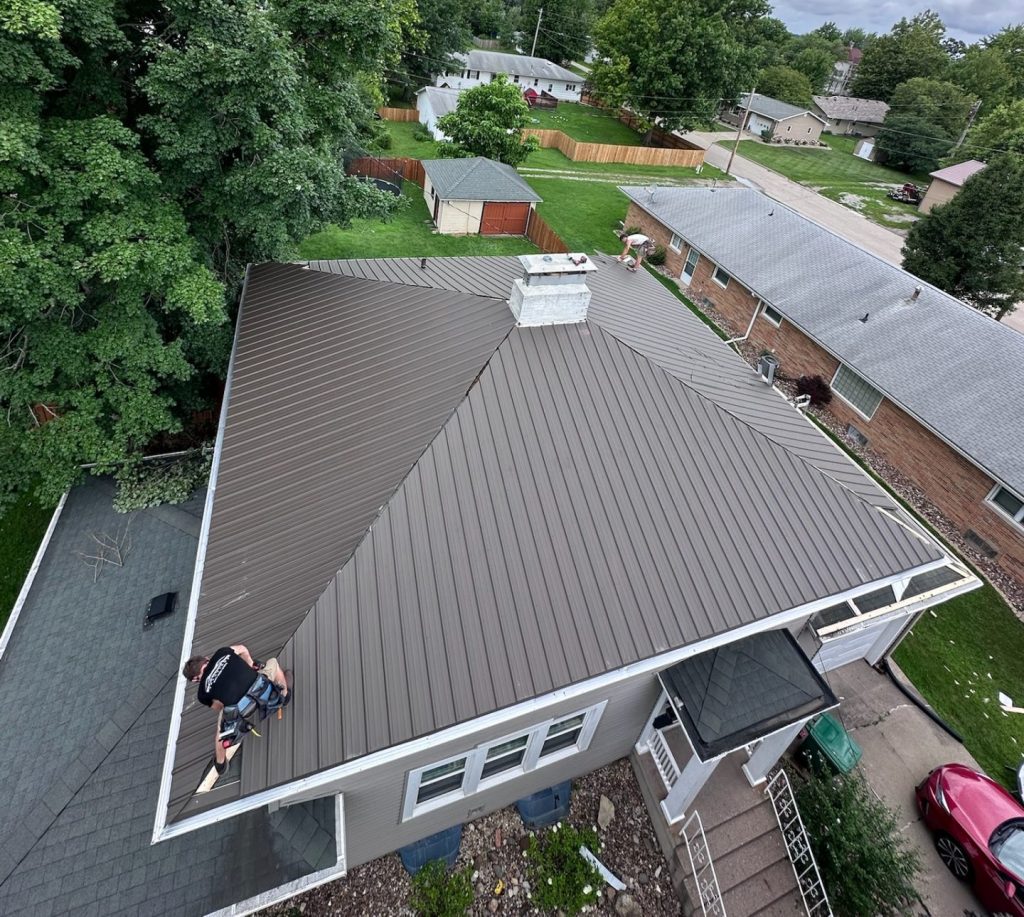 Standing seam metal roof installation on a residential home with concealed fasteners for durable, low-maintenance, energy-efficient, and sustainable performance.