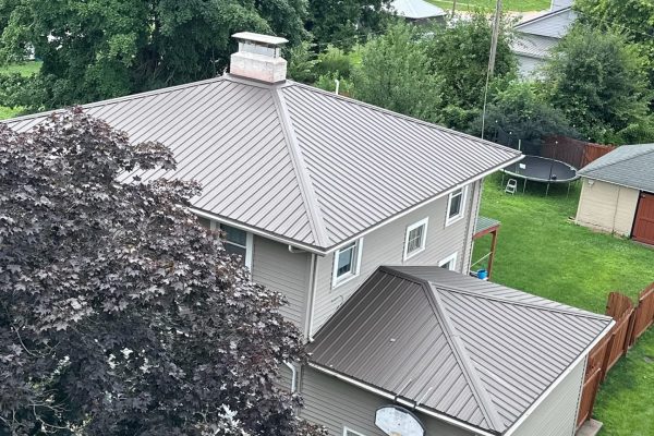 House featuring a standing seam metal roof system with raised seams for long-lasting, weather-resistant, energy-efficient, low-maintenance performance.