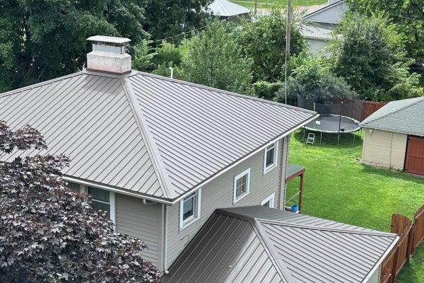 House featuring a standing seam metal roof system with raised seams for long-lasting, weather-resistant, energy-efficient, low-maintenance performance.