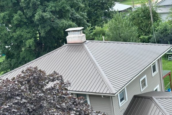 House featuring a standing seam metal roof system with raised seams for long-lasting, weather-resistant, energy-efficient, low-maintenance performance.