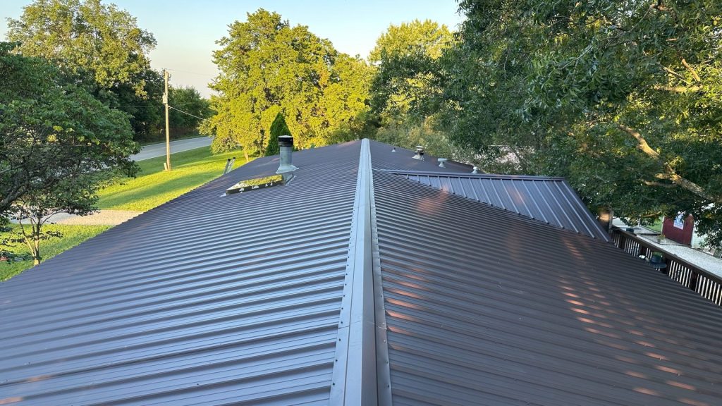 New standing seam metal roof installation with vertical interlocking panels, concealed fasteners, and a durable, energy-efficient, low-maintenance design.