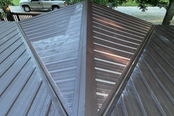 Brown standing seam metal roof with vertical seams and concealed fasteners, offering long-lasting, weather-resistant, energy-efficient, low-maintenance performance.