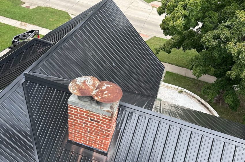 Modern residential building with a newly installed black standing seam metal roof featuring raised seams for durable, energy-efficient, low-maintenance performance.